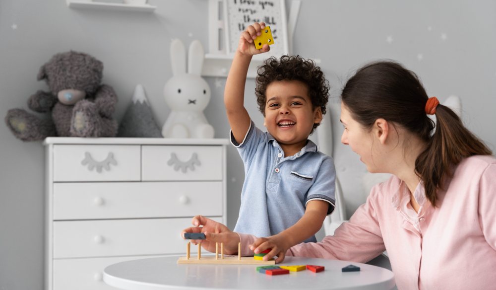 Joyful child engaged in a didactic game with an adult, illustrating the positive impact of Applied Behavior Analysis in learning environments.