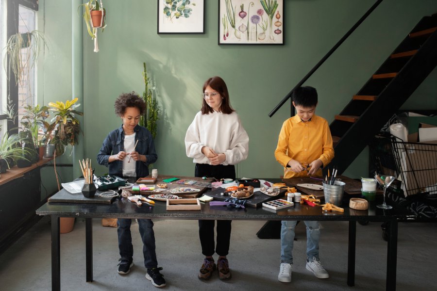 Group of young children engaged in a DIY project with upcycled materials, showcasing the benefits of art therapy for all ages.