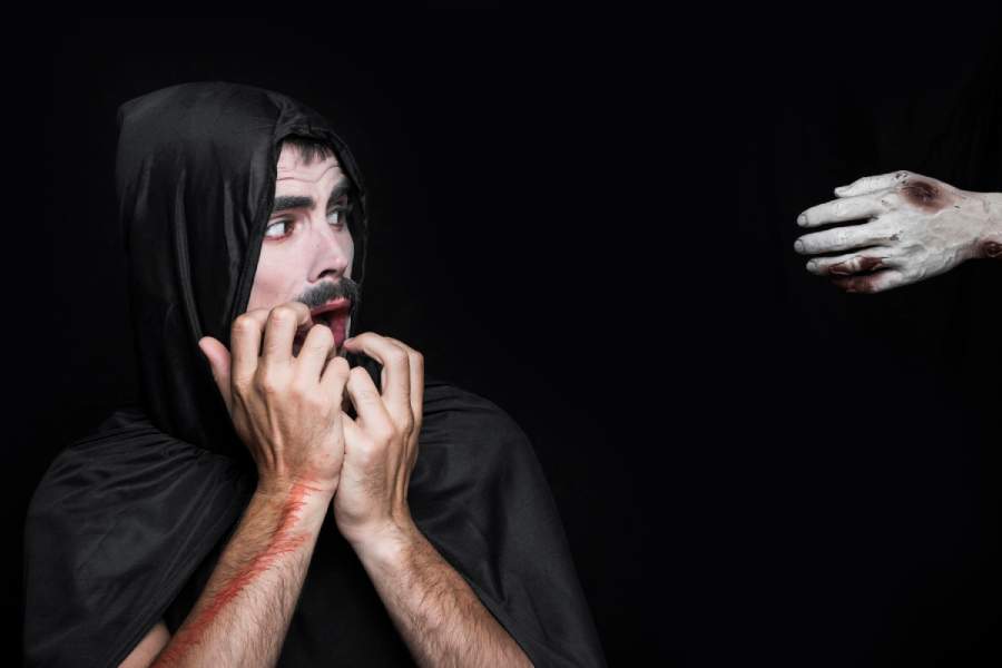 Image depicting a young man in a Halloween costume resembling a corpse hand. This illustration relates to types of personality disorders. 